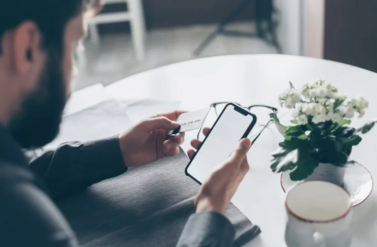 man-with-phone-credit-card-photo