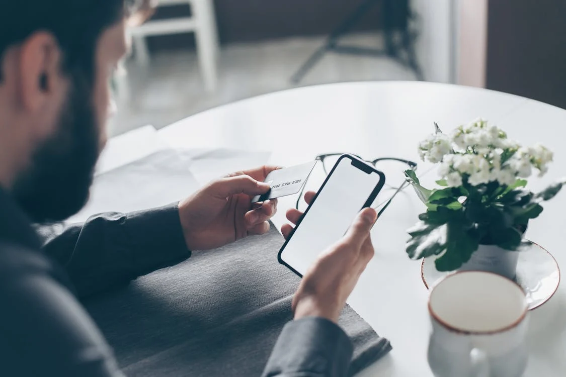 man-with-phone-credit-card-photo