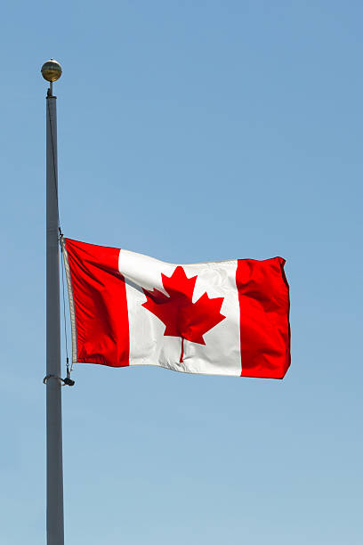 Canadian National Flag, Half-Mast against blue sky